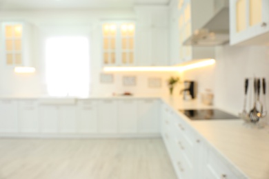 Photo of Blurred view of modern kitchen interior with stylish furniture