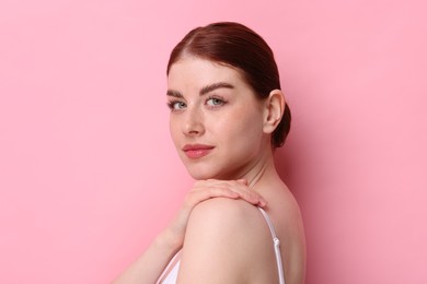 Photo of Portrait of beautiful woman on pink background