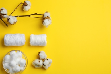 Flat lay composition with cotton rolls and balls on color background, space for text