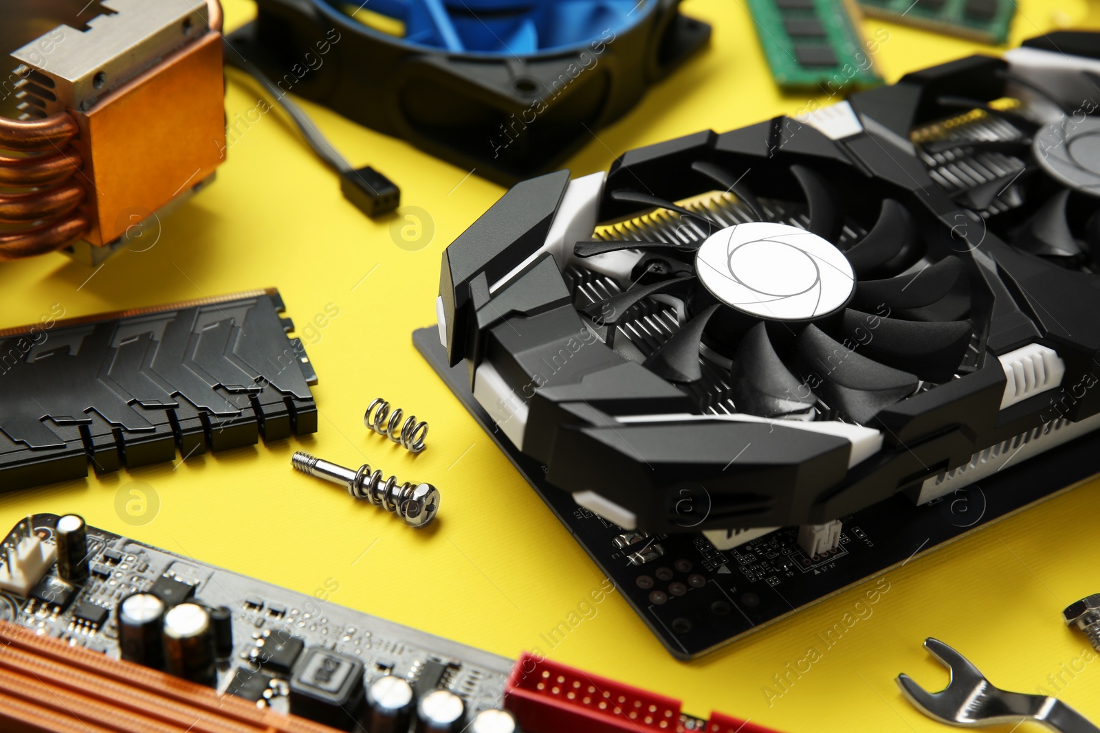 Photo of Graphics card and other computer hardware on yellow background, closeup