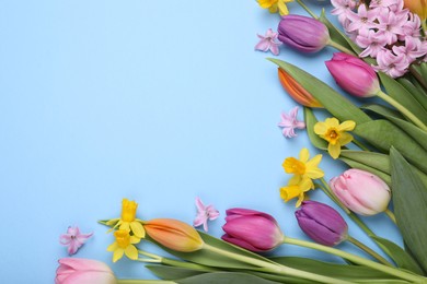 Photo of Beautiful flowers on light blue background, flat lay. Space for text