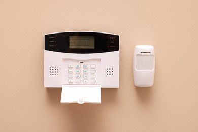 Photo of Home security alarm system on beige wall