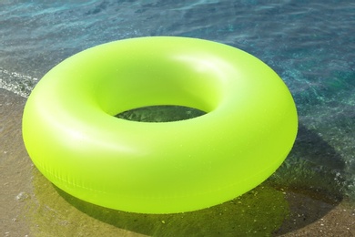 Photo of Bright inflatable ring near sea on sunny day