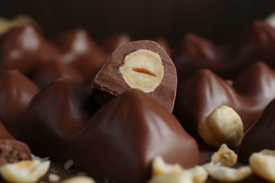 Photo of Pile of tasty chocolate bars with nuts, closeup