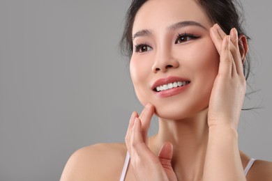 Photo of Portrait of beautiful woman on grey background