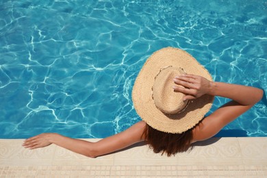 Photo of Woman wearing hat in swimming pool, above view