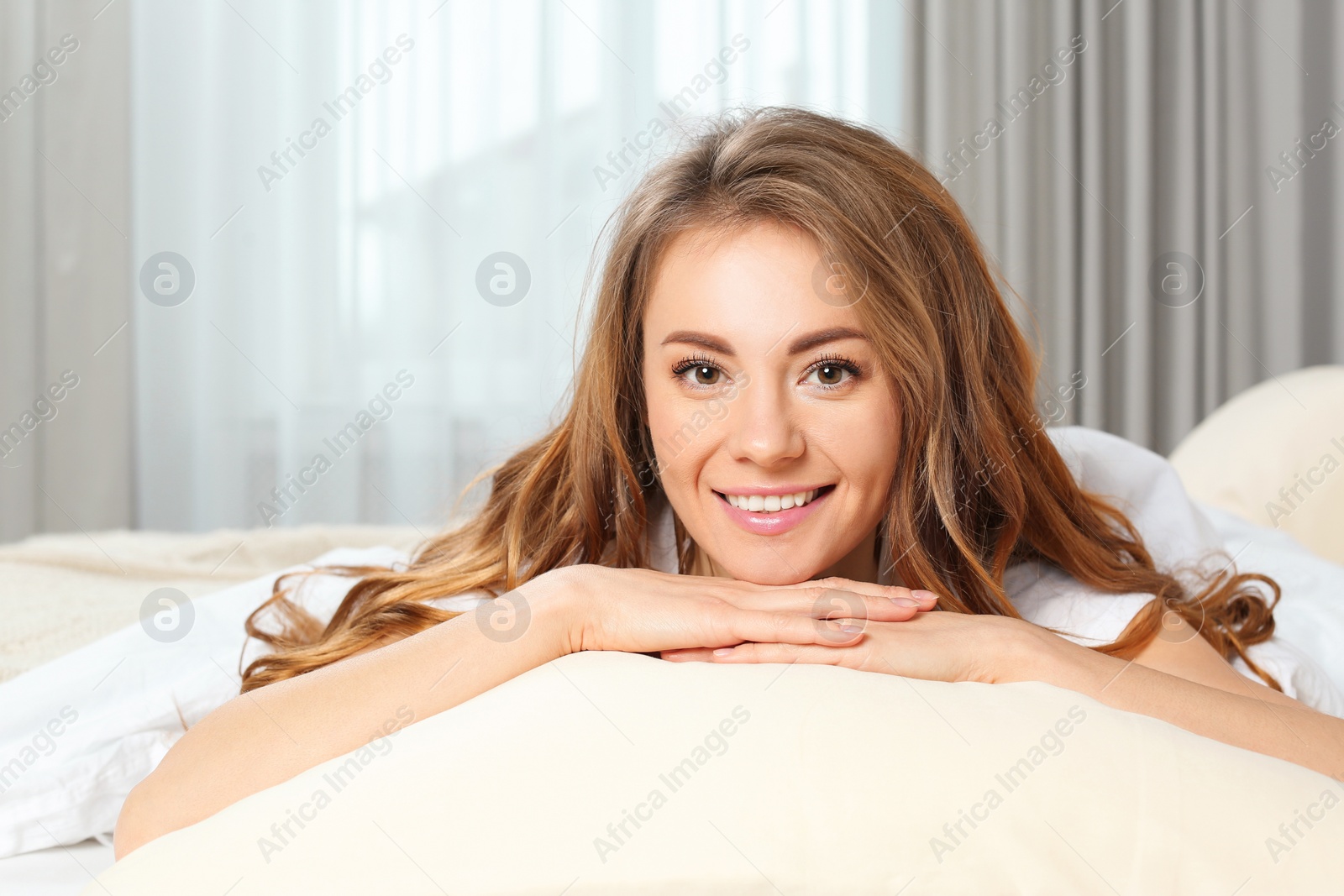 Photo of Portrait of happy beautiful woman in bed at home