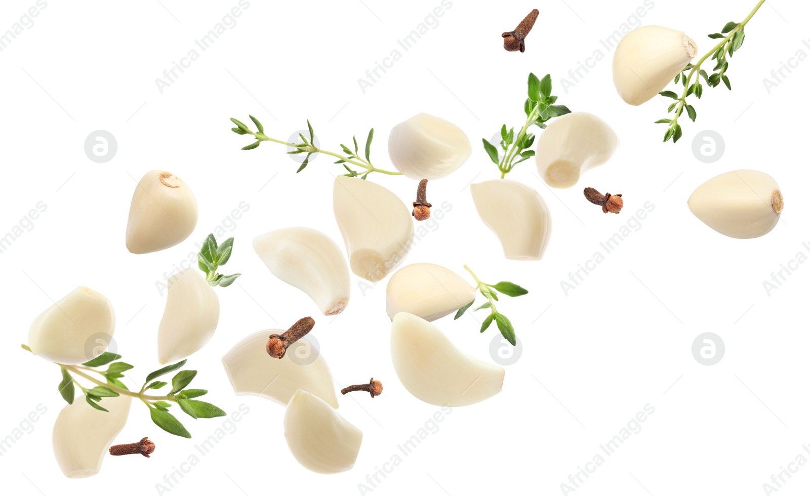 Image of Fresh peeled garlic, cloves and thyme flying on white background