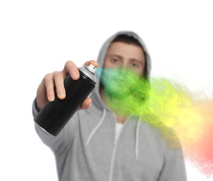 Handsome man spraying paint against white background