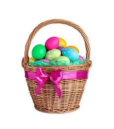 Wicker basket with bright painted Easter eggs on white background