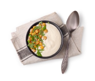 Photo of Tasty chickpea soup in bowl, spoon and napkin on white background, top view