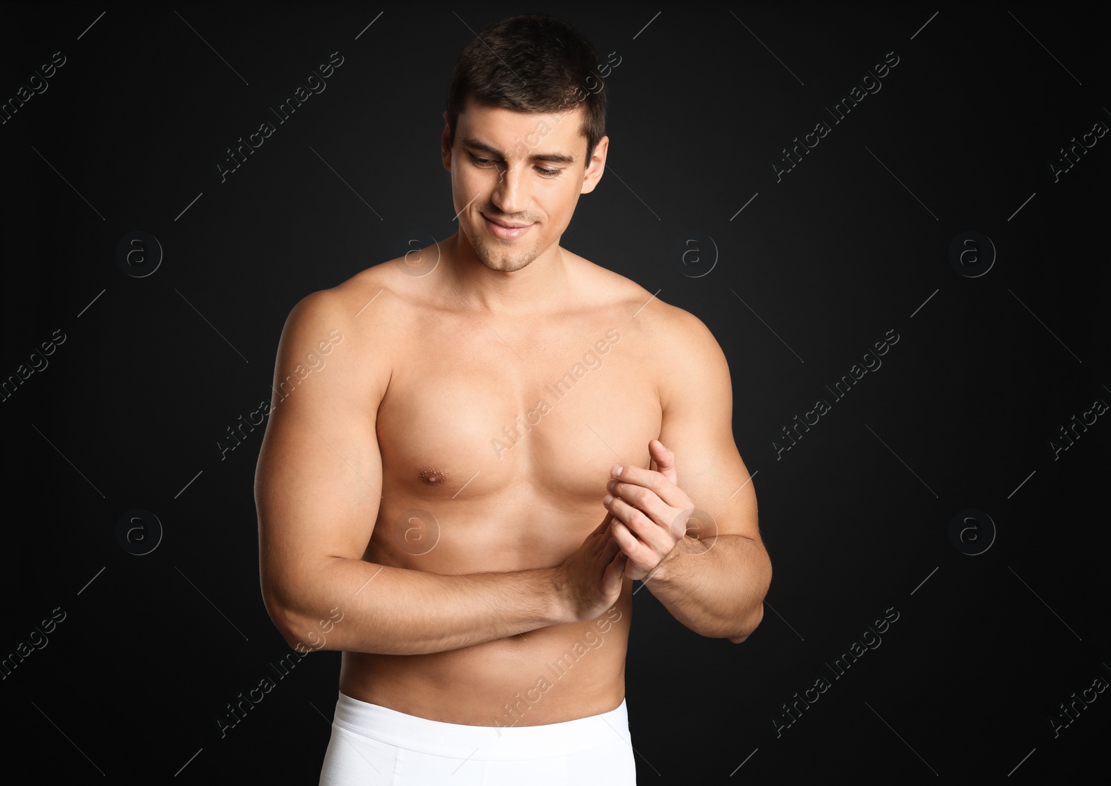 Photo of Man with sexy body on grey background. Space for text