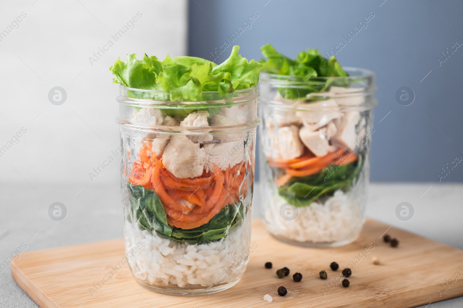 Photo of Healthy salad in glass jars on light table