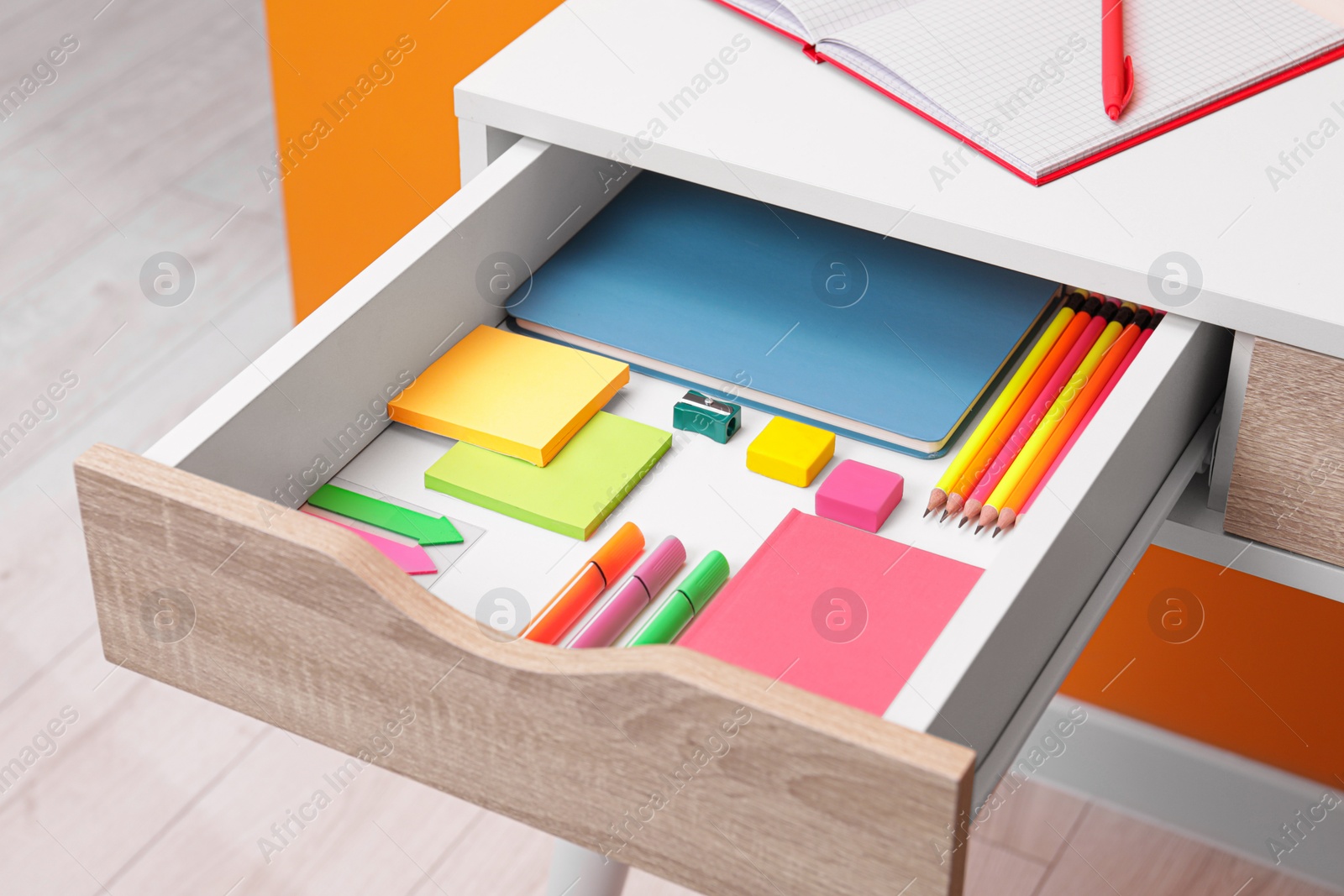 Photo of Office supplies in open desk drawer indoors