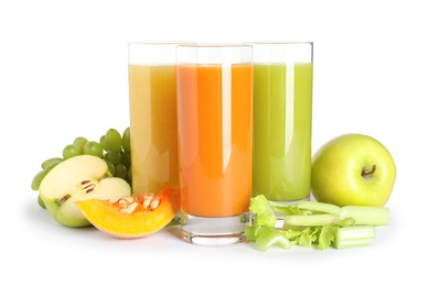 Glasses with different juices and fresh ingredients on white background