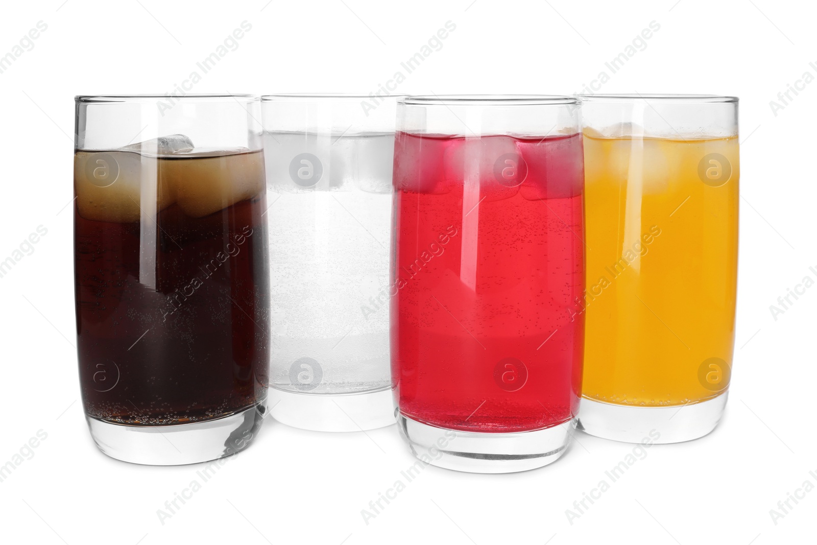 Photo of Glasses of different refreshing soda water with ice cubes on white background