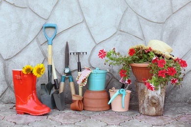 Photo of Set of gardening tools near wall outdoors