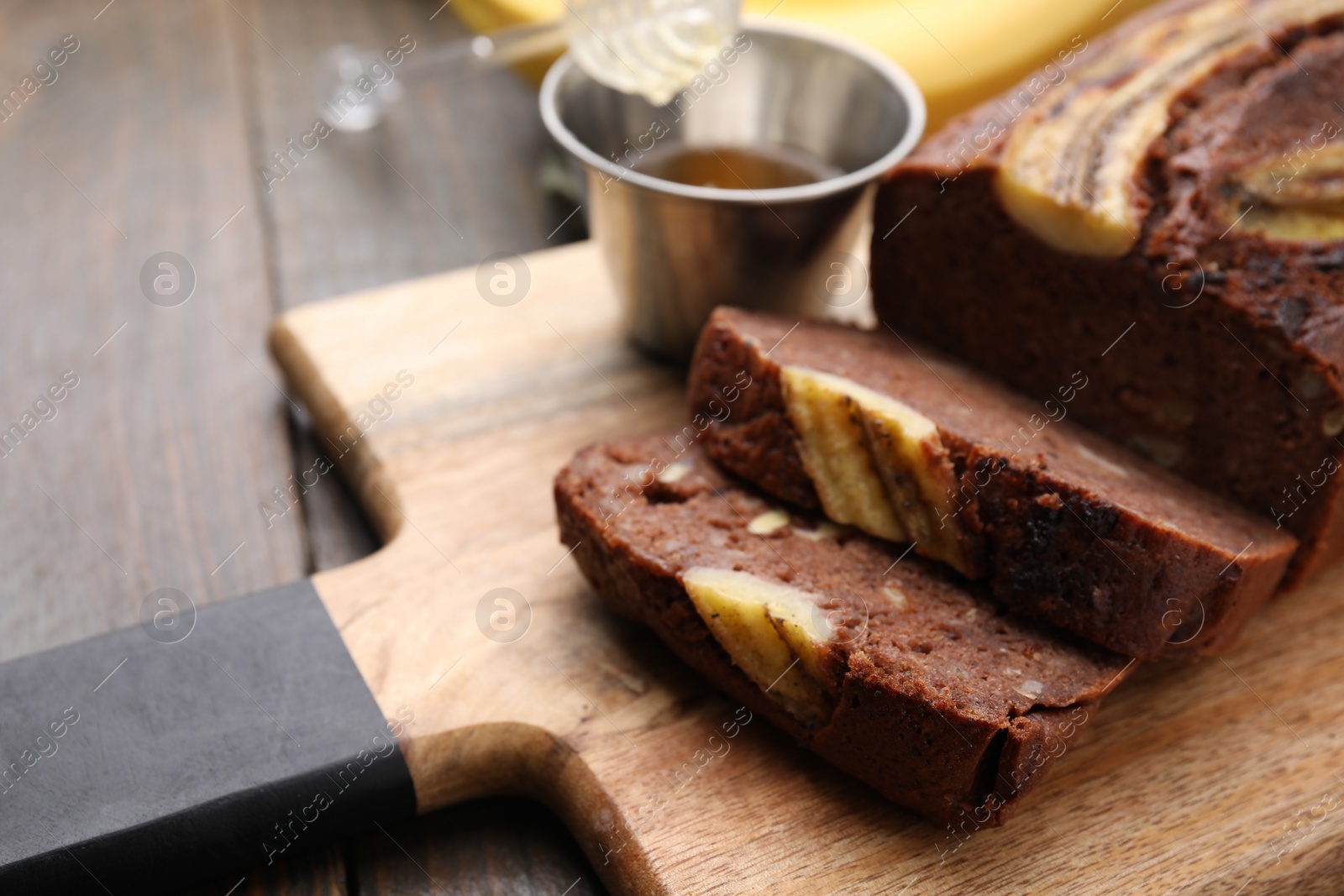 Photo of Delicious banana bread on wooden table, closeup. Space for text