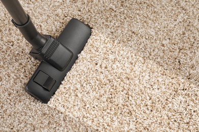 Hoovering carpet with vacuum cleaner, top view and space for text. Clean trace on dirty surface