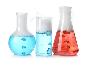 Laboratory glassware with colorful liquids and steam isolated on white. Chemical reaction