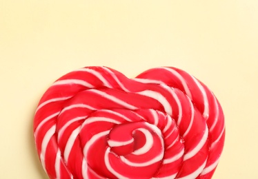 Sweet heart shaped lollipop on beige background, top view. Valentine's day celebration