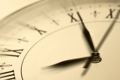Fleeting time concept. Clock on light background, closeup. Motion effect