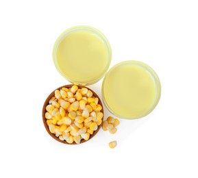 Photo of Tasty fresh corn milk in glasses and kernels on white background, top view