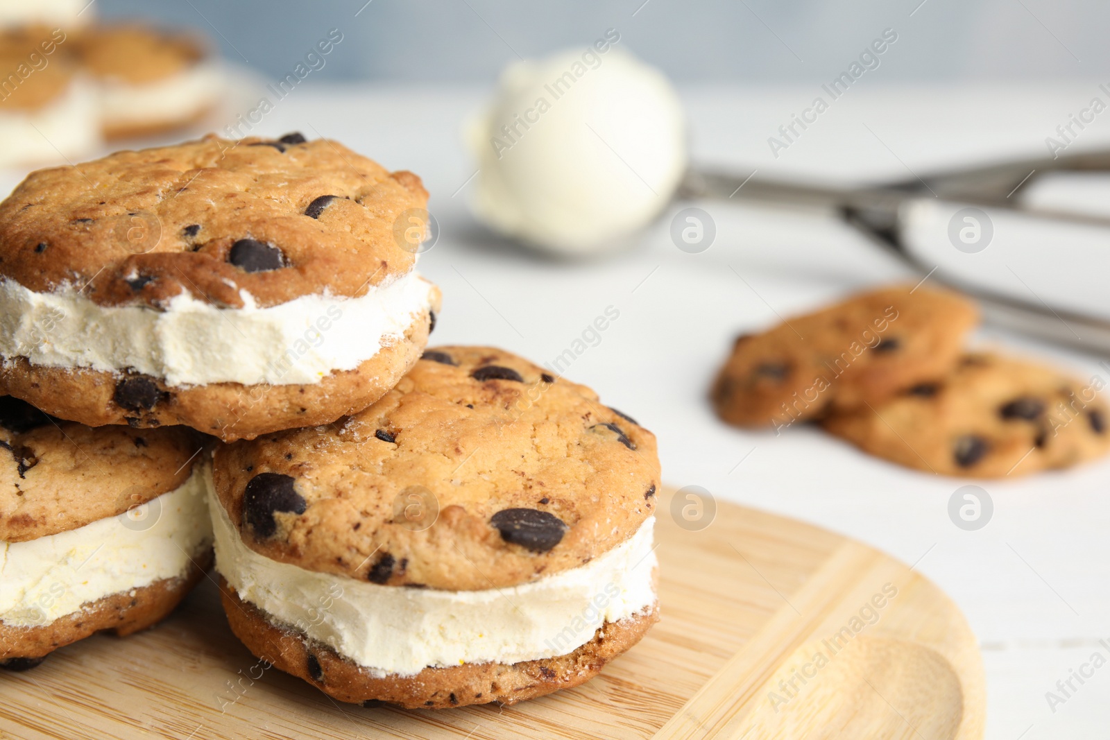 Photo of Sweet delicious ice cream cookie sandwiches on table, closeup. Space for text