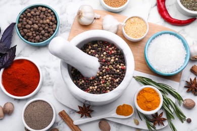 Photo of Flat lay composition with mortar and different spices on white marble table