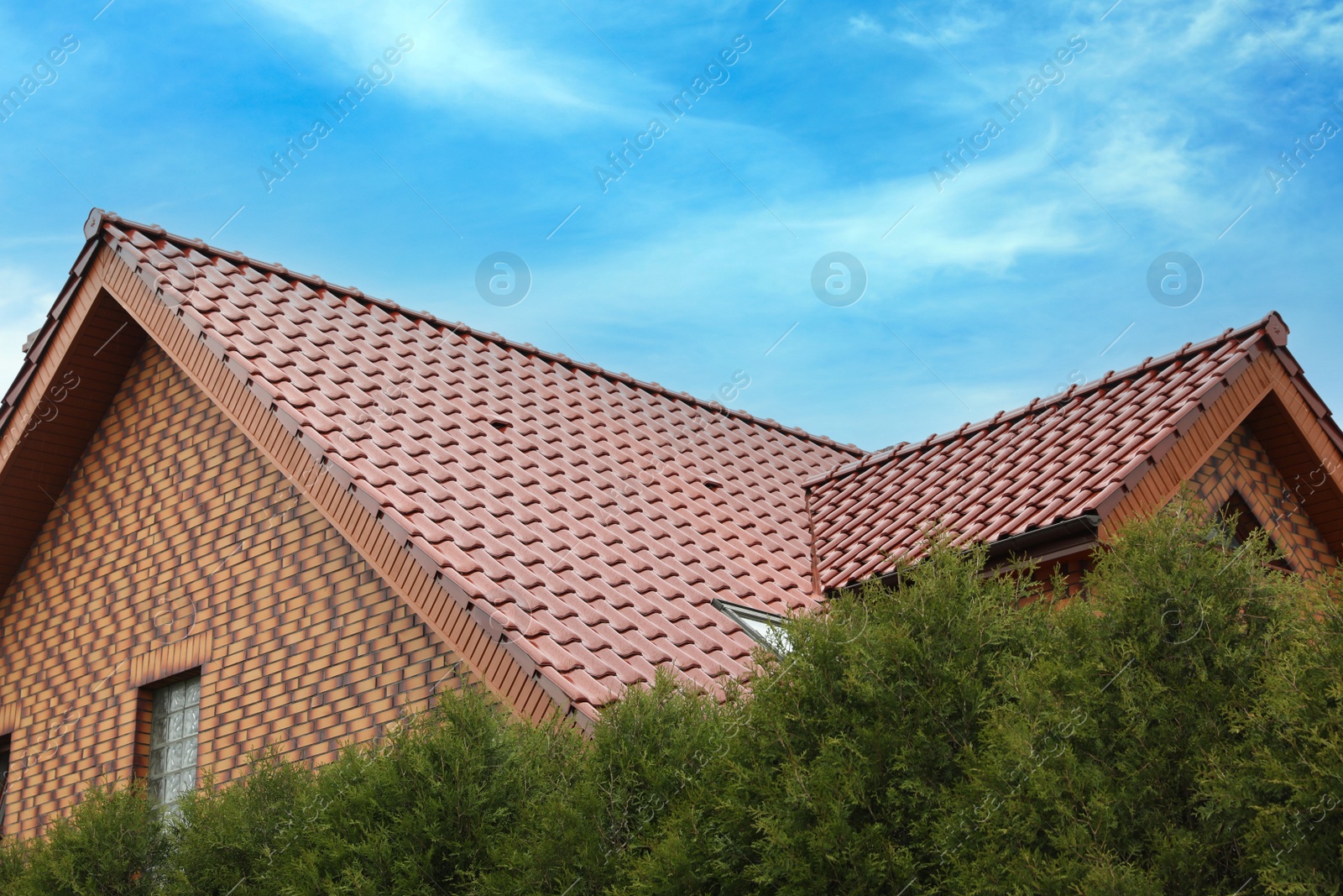 Photo of Beautiful house with red roof against blue sky