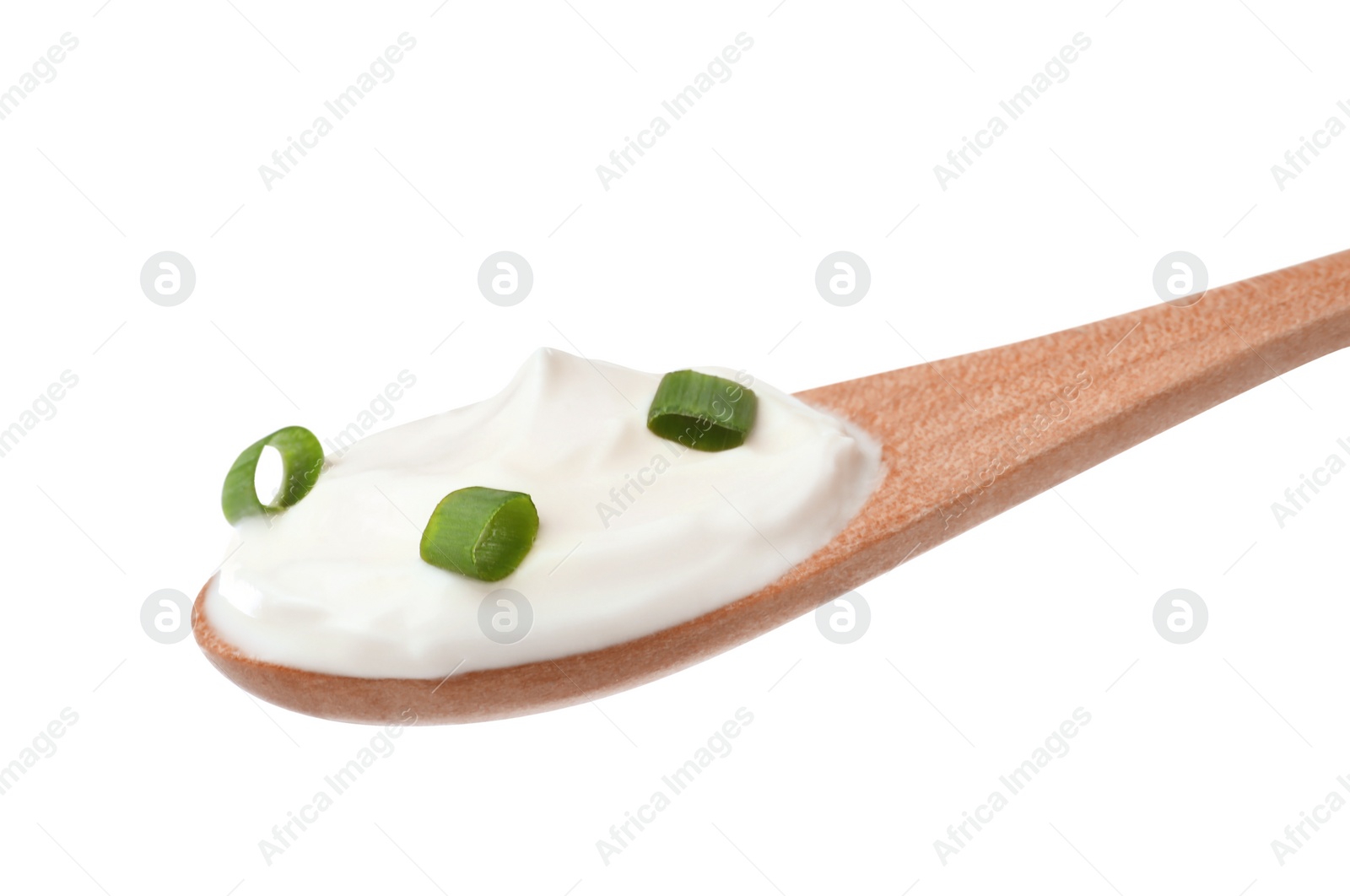 Photo of Delicious sour cream with onion in wooden spoon isolated on white