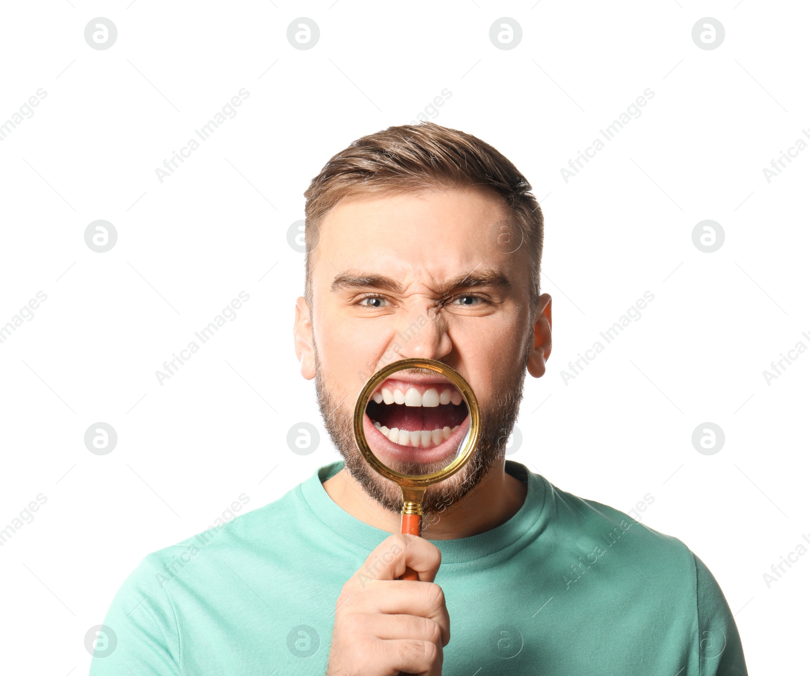 Photo of Young man with healthy teeth and magnifier on white background