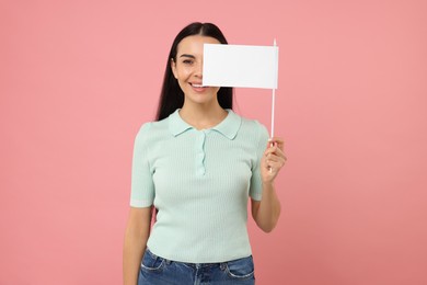 Happy young woman with blank white flag on pink background. Mockup for design