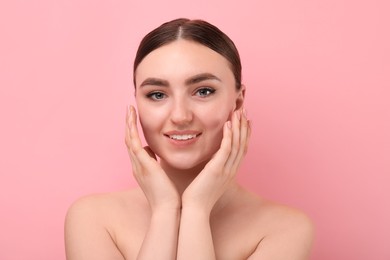 Makeup product. Woman with black eyeliner and beautiful eyebrows on pink background