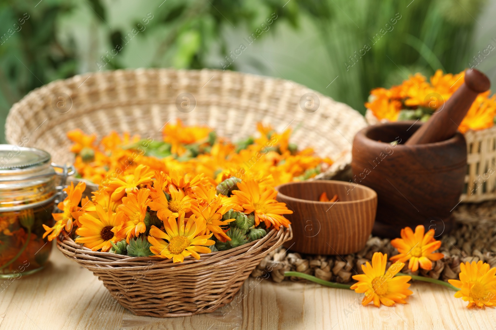 Photo of Many beautiful fresh calendula flowers on table