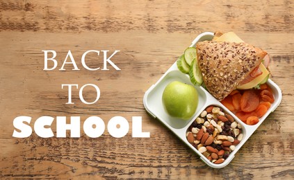 Lunch box with tasty food on wooden background, top view