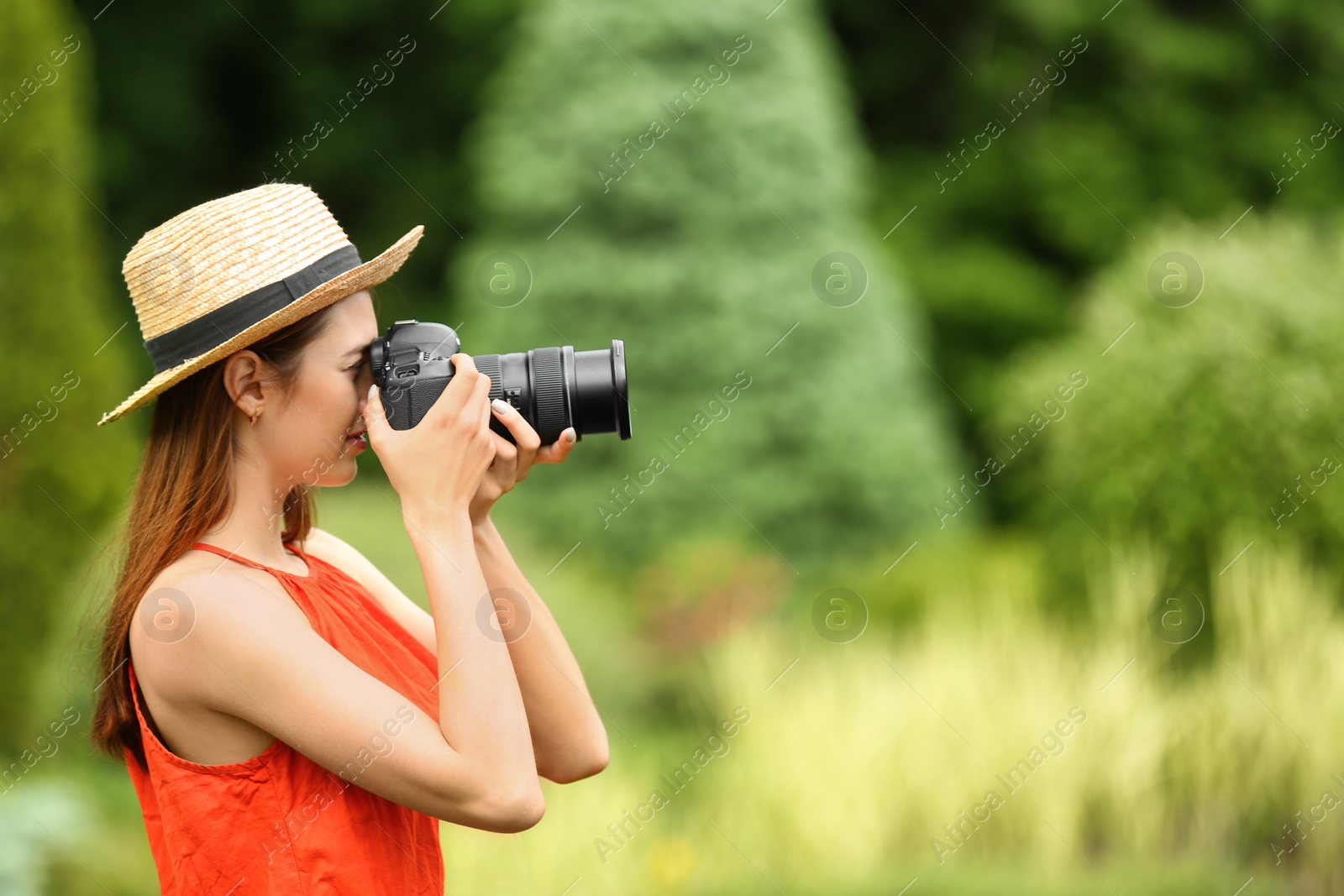 Photo of Photographer taking photo with professional camera in park