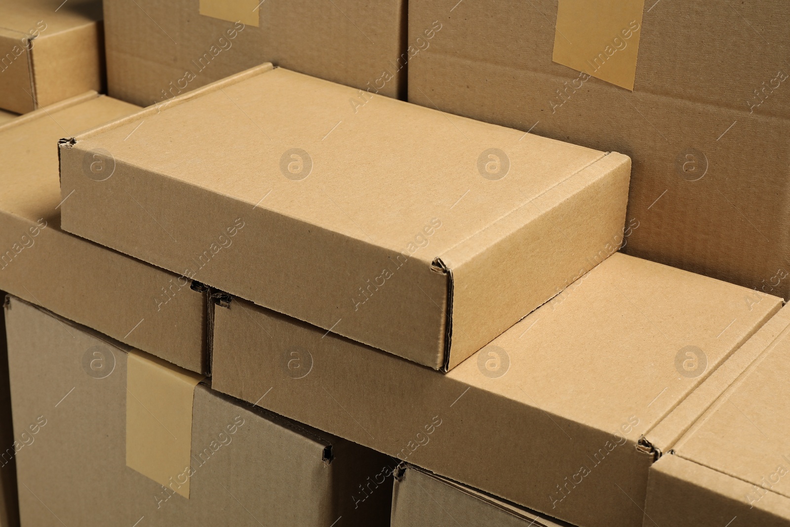 Photo of Many cardboard boxes as background, closeup. Packaging goods