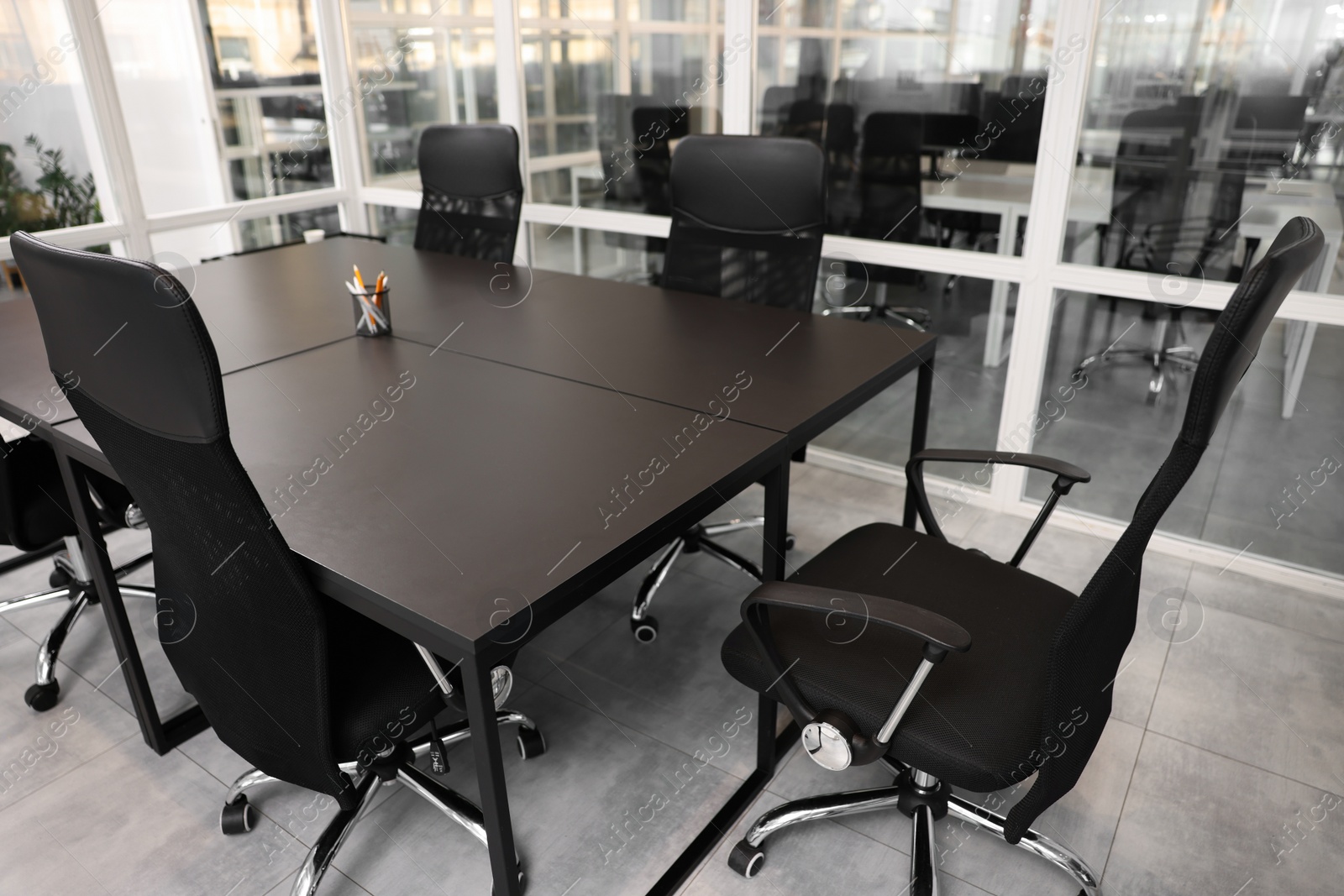 Photo of Comfortable office chairs and tables in meeting room