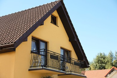 Photo of Exterior of beautiful house with balcony on sunny day