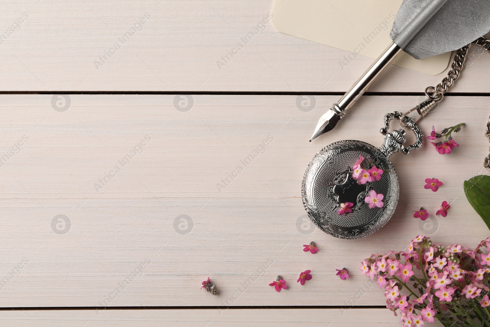 Photo of Flat lay composition with beautiful Forget-me-not flowers on white wooden table. Space for text