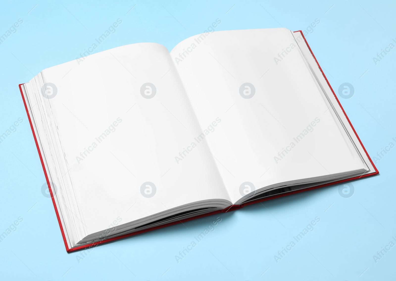 Photo of Open book with blank pages on turquoise background. Space for text