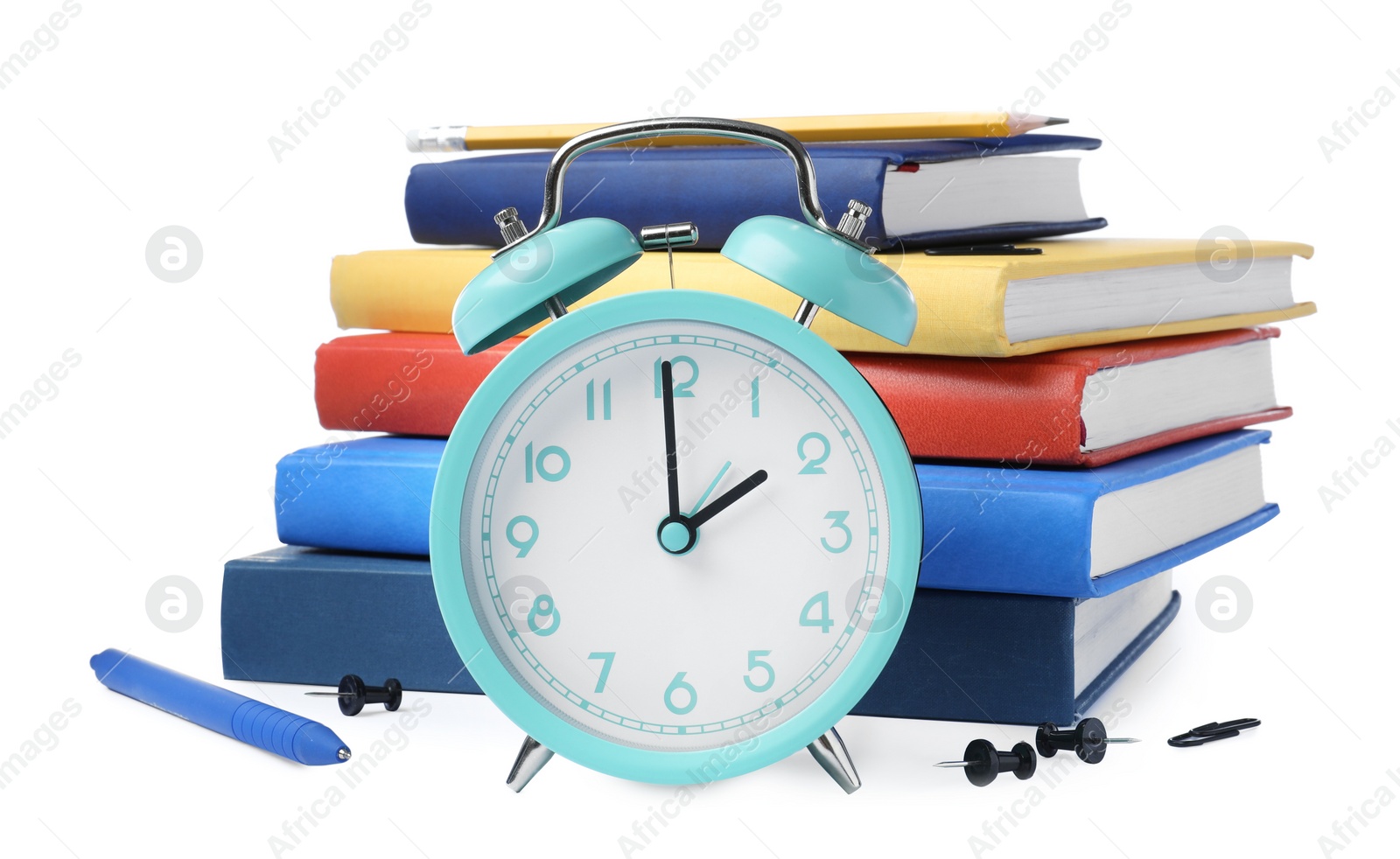 Photo of Turquoise alarm clock and different stationery on white background. School time