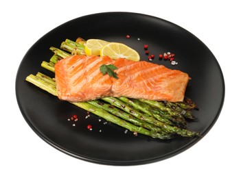 Tasty grilled salmon with asparagus, lemon and spices isolated on white