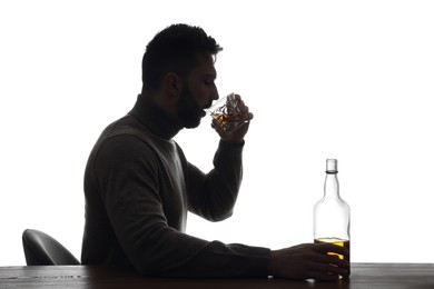 Photo of Silhouette of addicted man drinking alcohol on white background