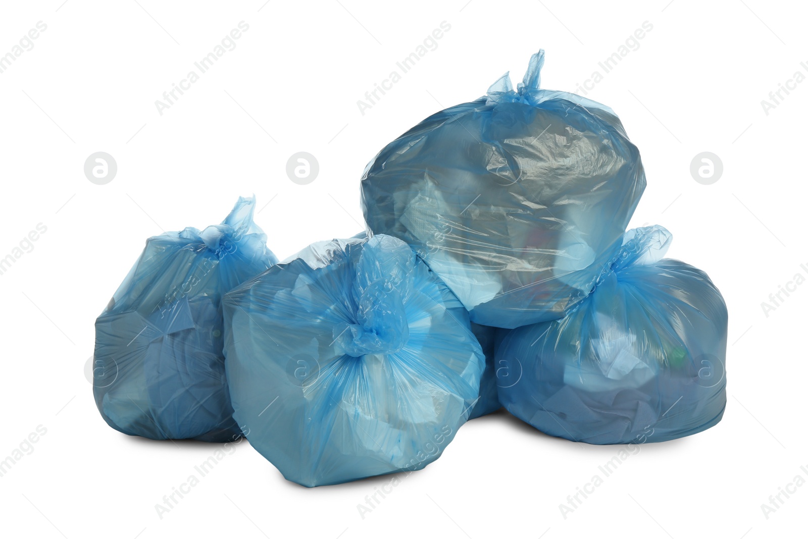 Photo of Blue trash bags filled with garbage on white background