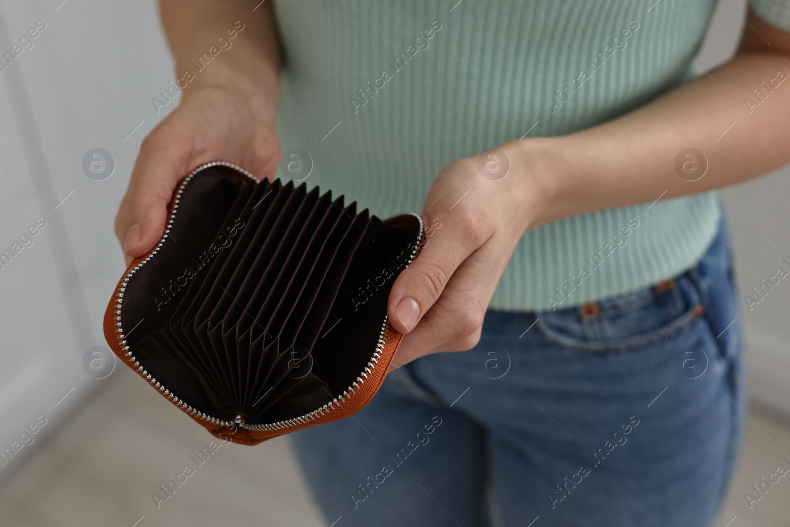 Photo of Woman with empty wallet at home, closeup