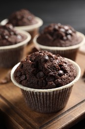 Delicious chocolate muffins on table, closeup view