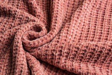 Beautiful pink knitted fabric as background, closeup