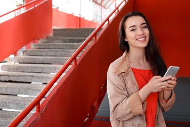 Young woman using mobile phone outdoors